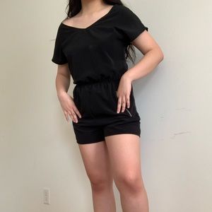 Black wideneck romper with gold accent zippers